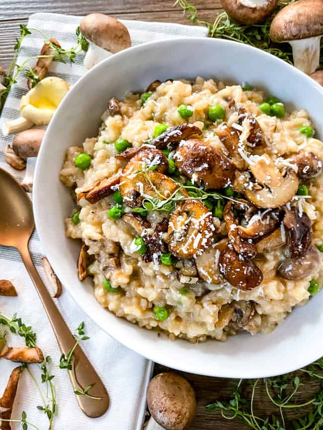 Mushroom Pea Risotto in a bowl on top of a towel