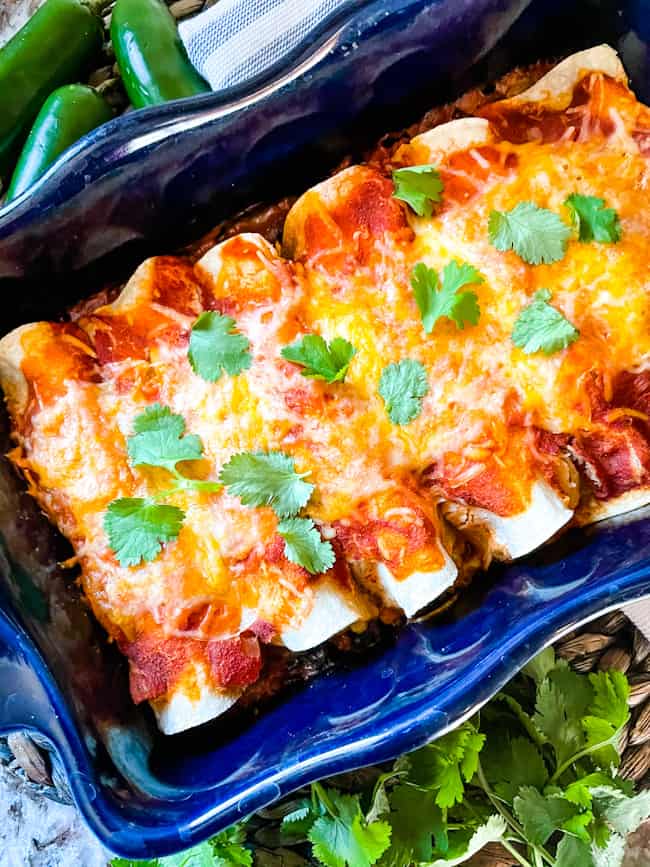 A blue dish filled with Southwest Ground Turkey Enchiladas