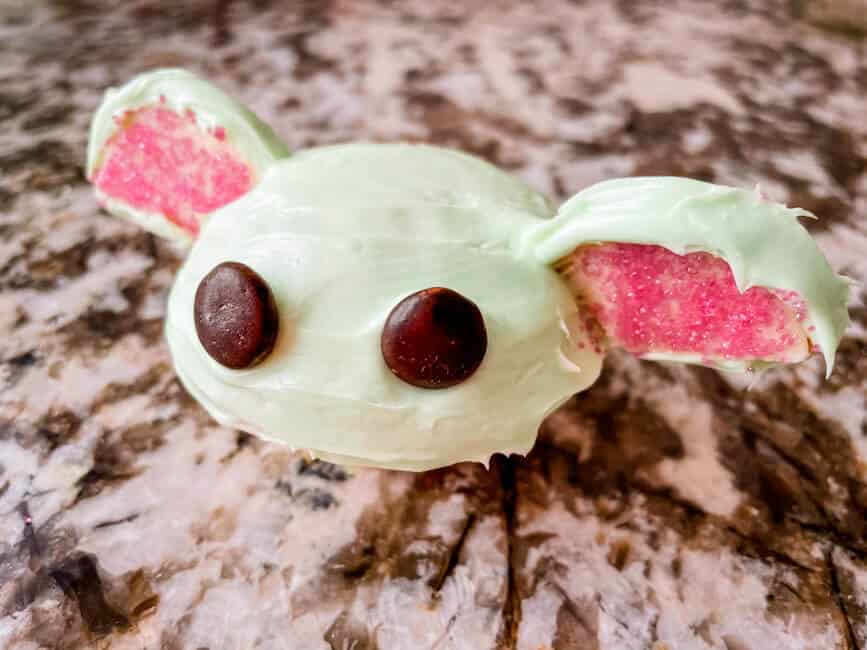 A Baby Yoda Cupcake on marble counter