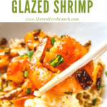 Pin image of chopsticks holding a Chipotle Orange Glazed Shrimp over a bowl