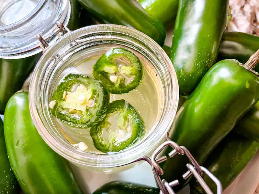 The sugar syrup with peppers in and around the jar