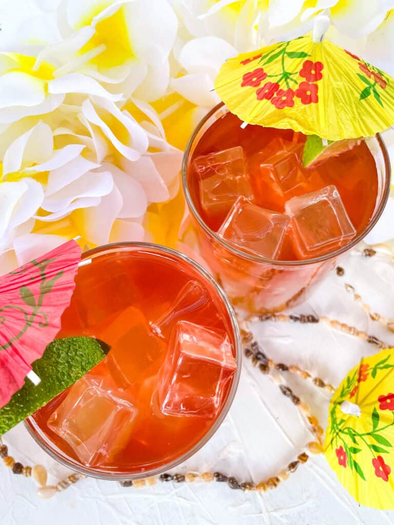 Top view of two glasses of Malibu Bay Breeze cocktail with umbrellas in them