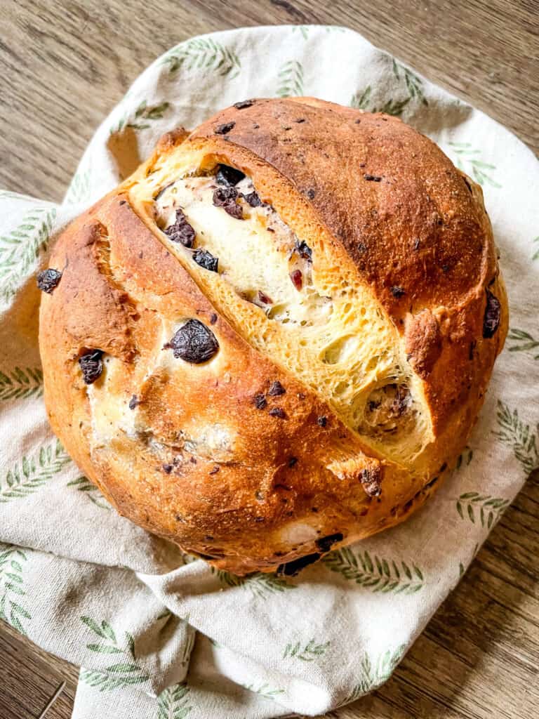 A loaf of Sourdough Olive Bread on a towel