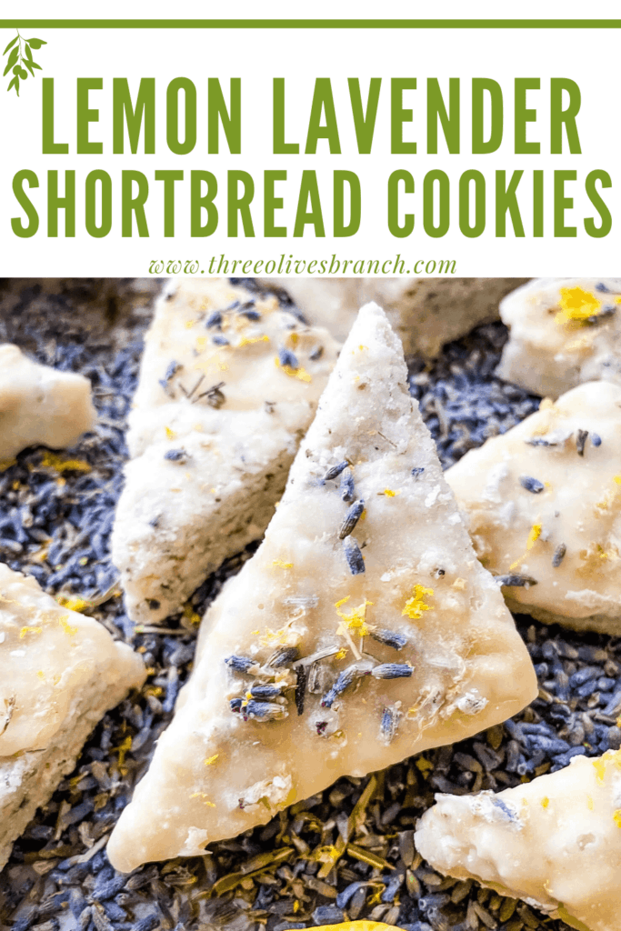 Close up of a Lemon Lavender Shortbread Cookie on lavender buds with title at top