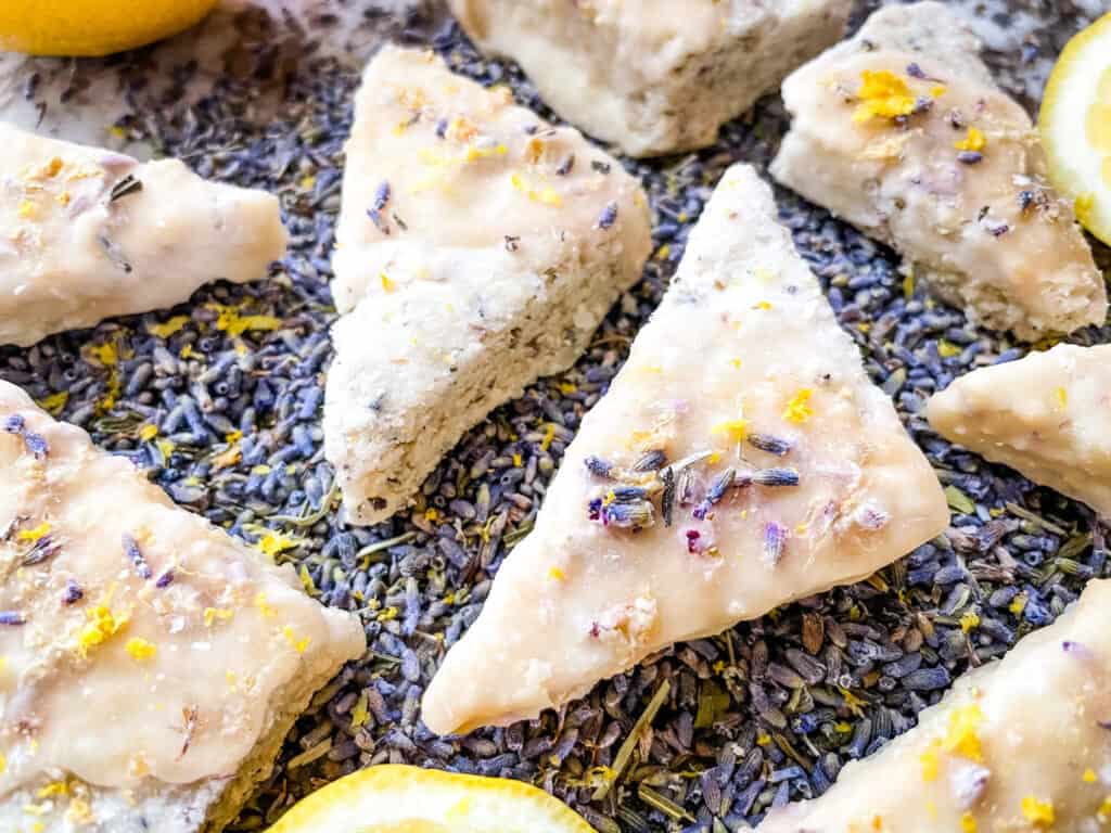 A bunch of Lemon Lavender Shortbread Cookies spread out over lavender flowers