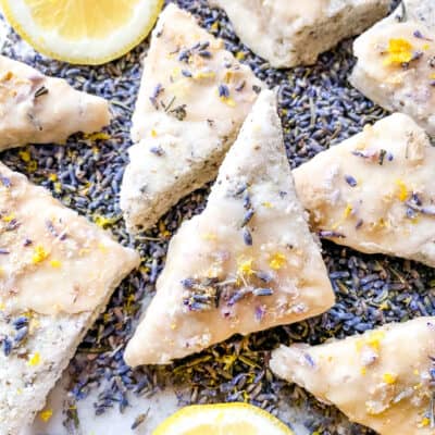 A pile of Lemon Lavender Shortbread Cookies on purple flower buds