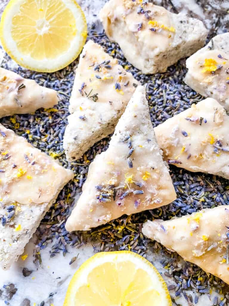 A pile of Lemon Lavender Shortbread Cookies on purple flower buds