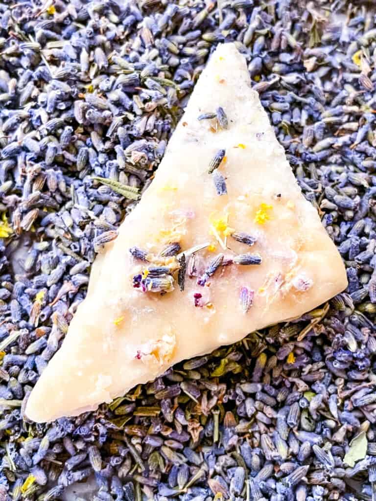 A single triangular cookie on the purple flower buds