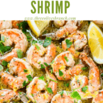 Pin image of Lemon Pepper Shrimp in a skillet with lemon wedges and title at top