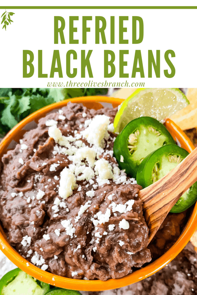 Pin image of Black Refried Beans in a bowl with wood spoon and title at top