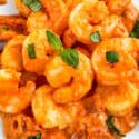 Close view of Shrimp in Vodka Sauce in a pile on a white plate