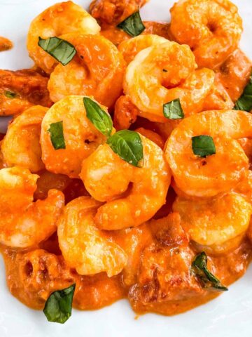 Close view of Shrimp in Vodka Sauce in a pile on a white plate
