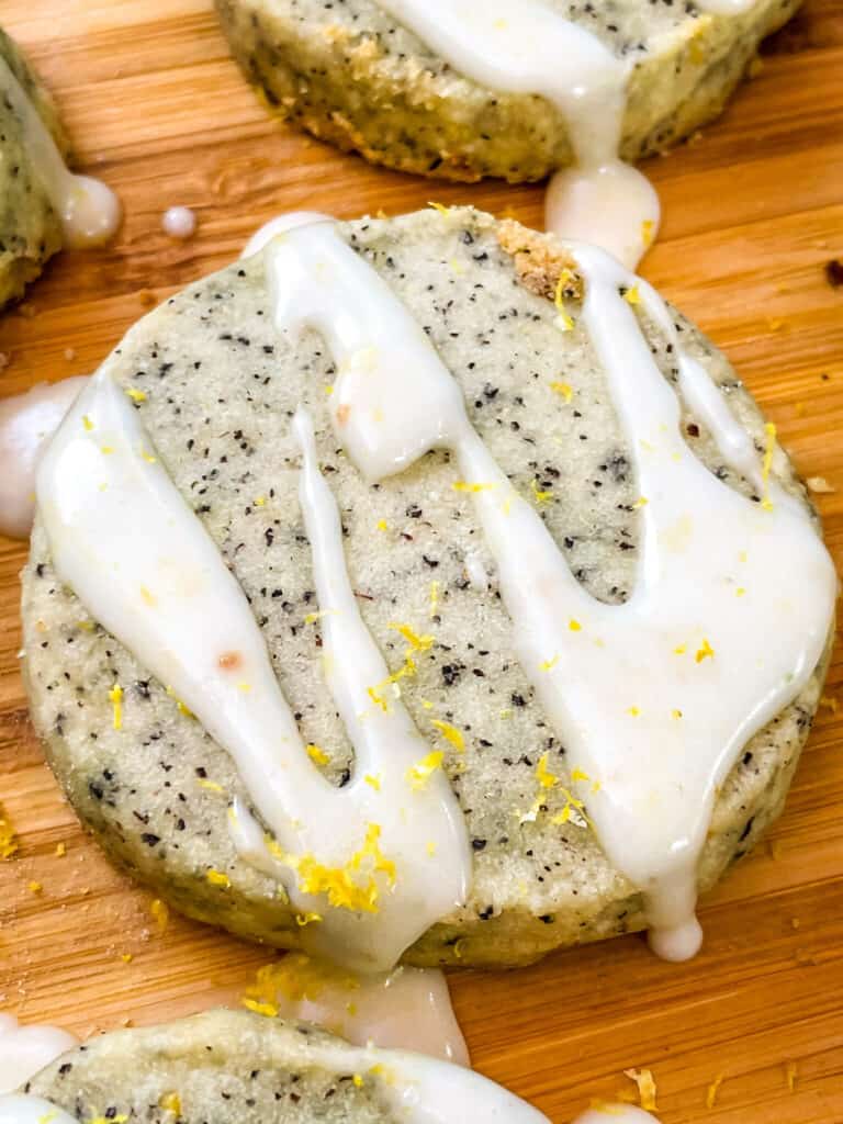 One Earl Grey Shortbread Cookie with glaze and some lemon zest on it