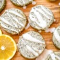 Earl Grey Shortbread Cookies spread out on a cutting board with drizzled glaze and lemon slices