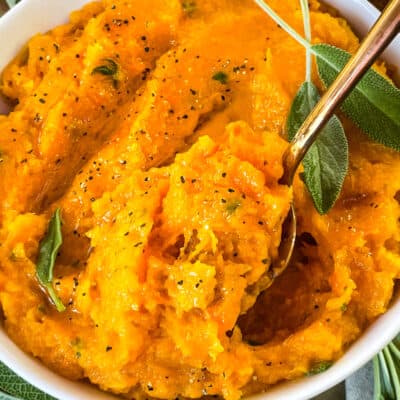 A spoon digging into a bowl of the vegetable