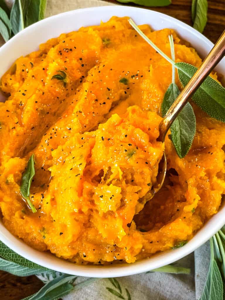 A spoon digging into a bowl of the vegetable