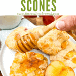 Pin image of a hand drizzling honey on Peach Scones with title at top