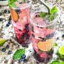 Two glasses of Blueberry Mojito cocktails