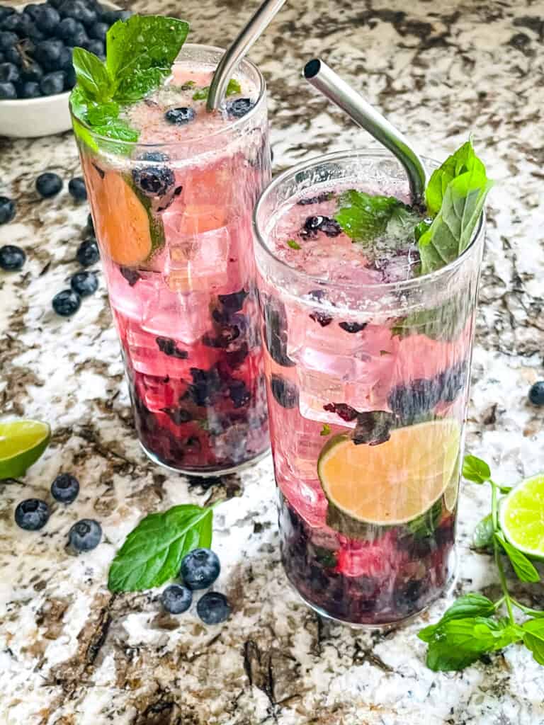 Two glasses of Blueberry Mojito cocktails