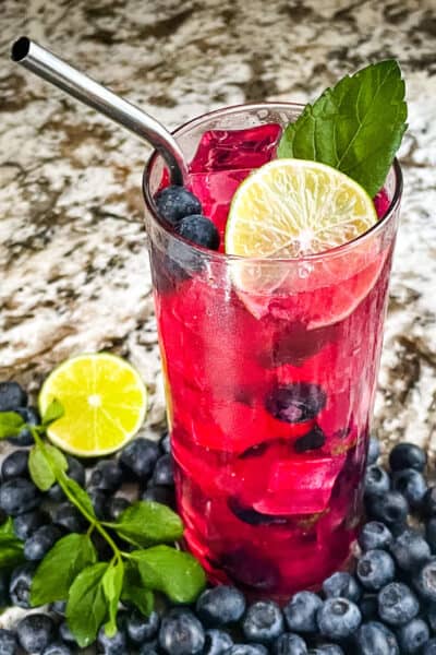 A bright pink Blueberry Mojito after being stirred