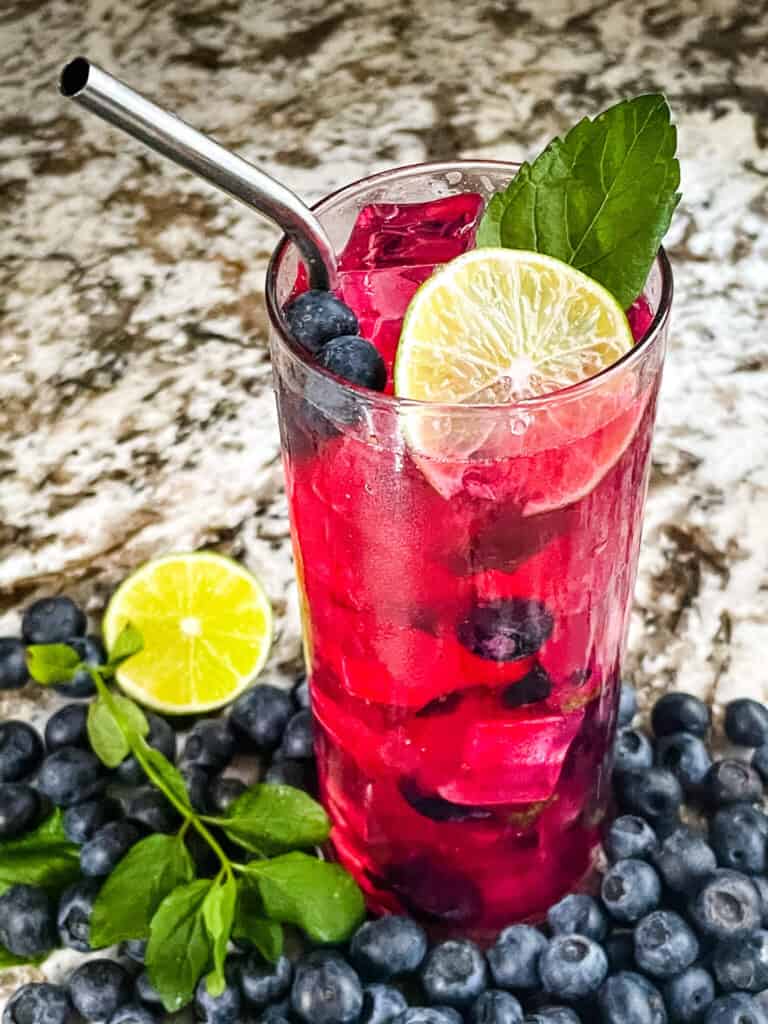 A bright pink Blueberry Mojito after being stirred