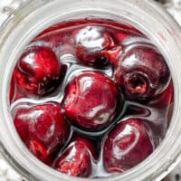 Top view of a jar full of Brandied Cherries