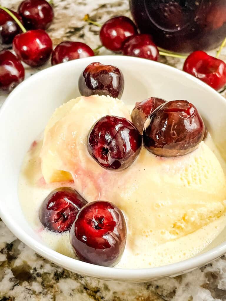 Brandied Cherries on top of ice cream in a bowl