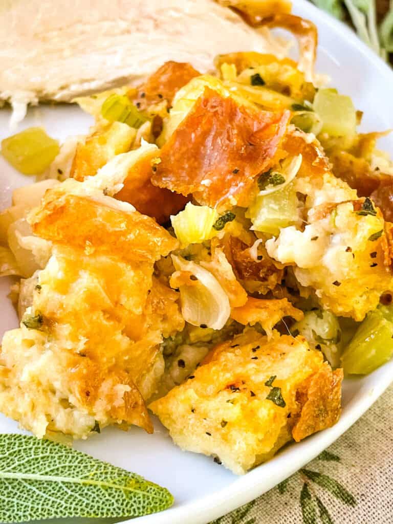 A pile of Onion and Sage Stuffing (Dressing) on a white plate