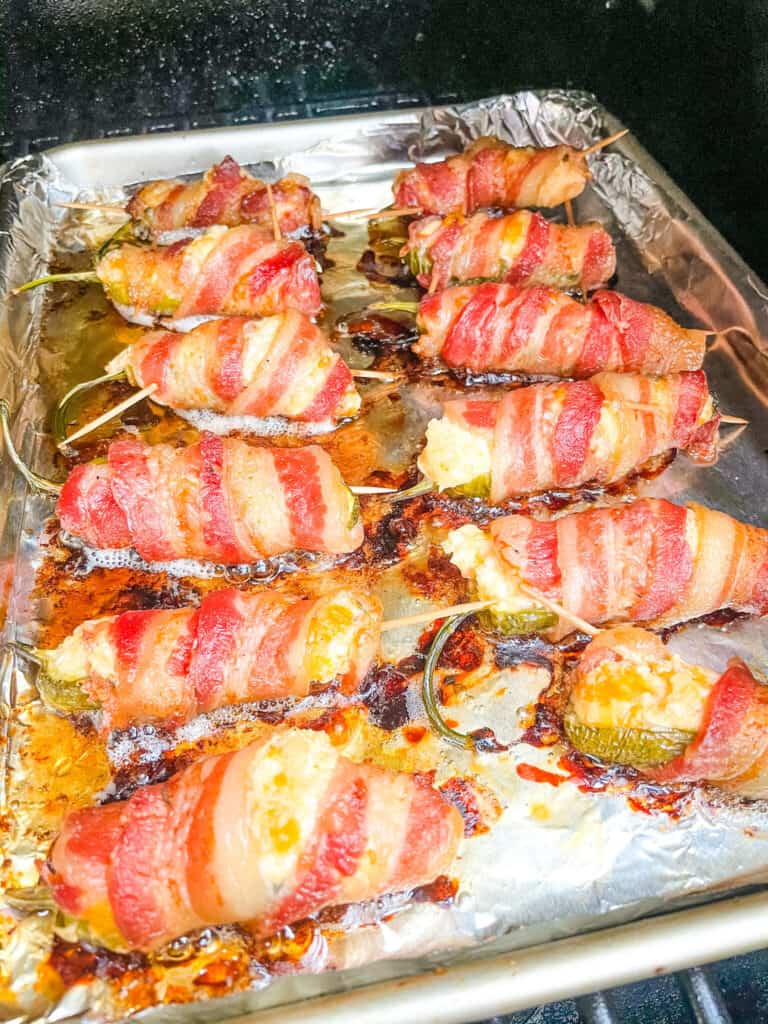 Smoked Jalapeno Poppers smoking in a smoker on a tray