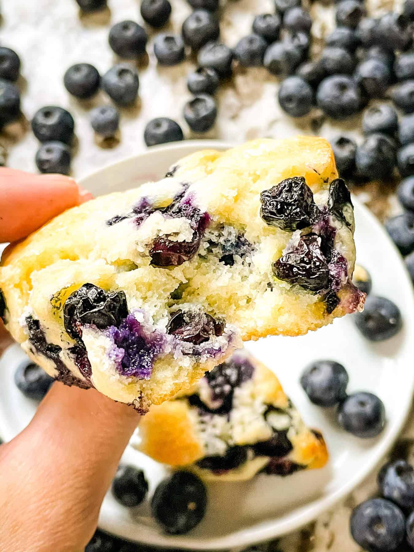 A hand holding half a scone with view of the inside