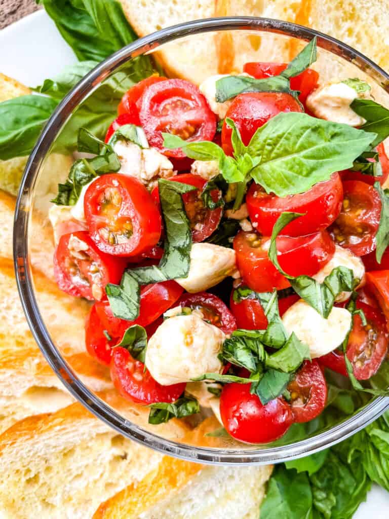 Basil, tomato, and cheese in a bowl