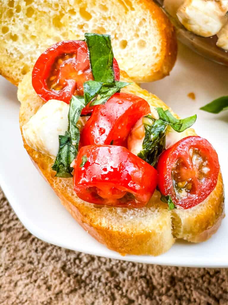 A single piece of Bruschetta with Mozzarella (Caprese Bruschetta) up close