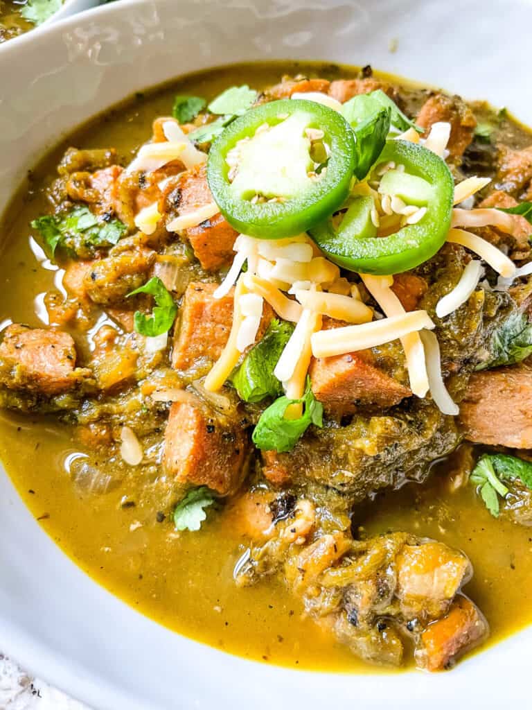 The Hatch Pork Green Chili in a bowl with toppings
