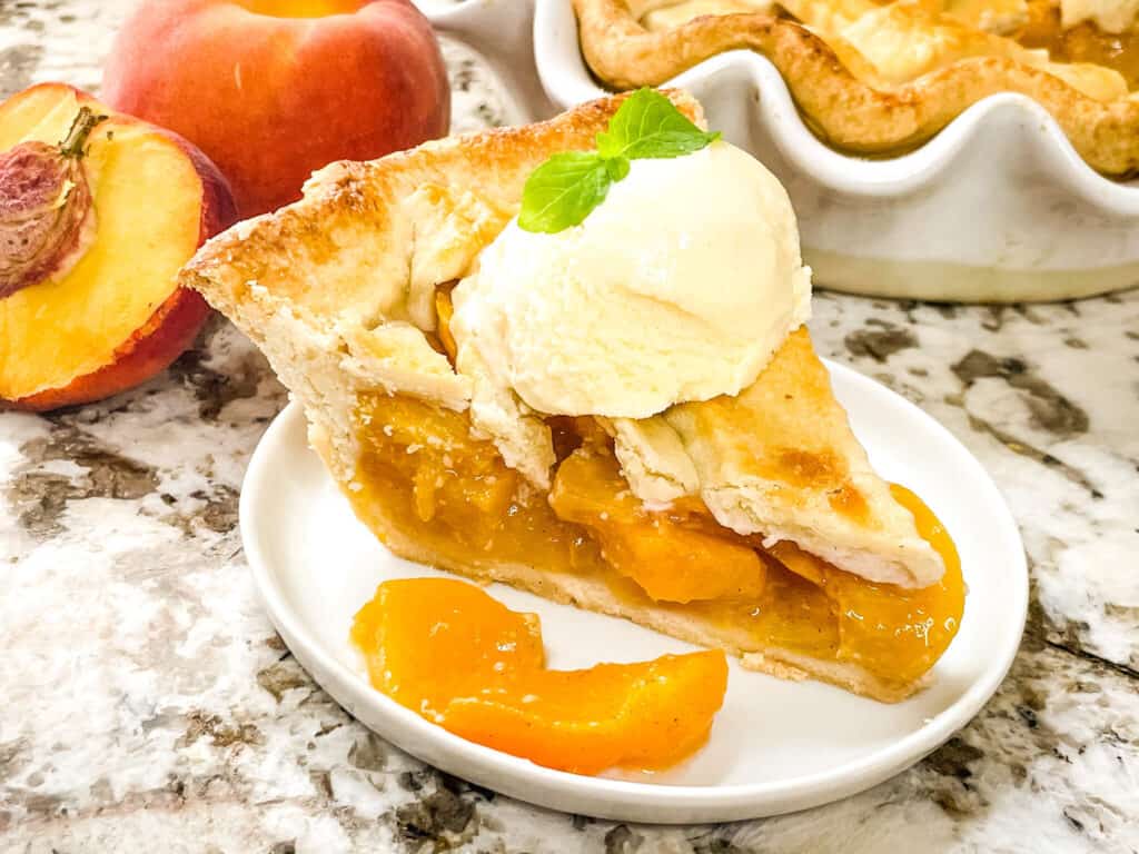 Peach pie with ice cream on a plate