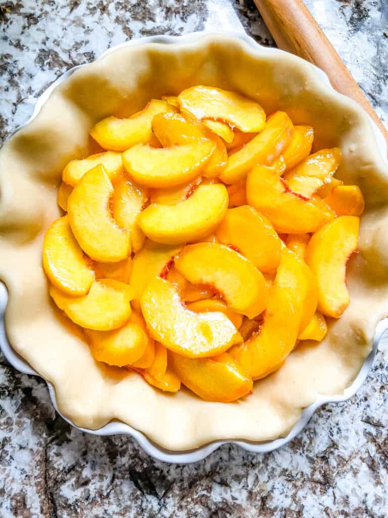 Top view of peach pie filling in a crust