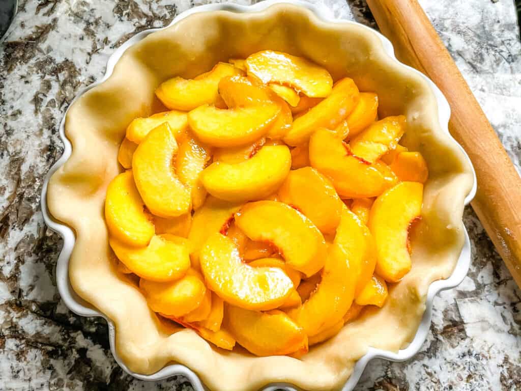 Pie crust filled with peach pie filling