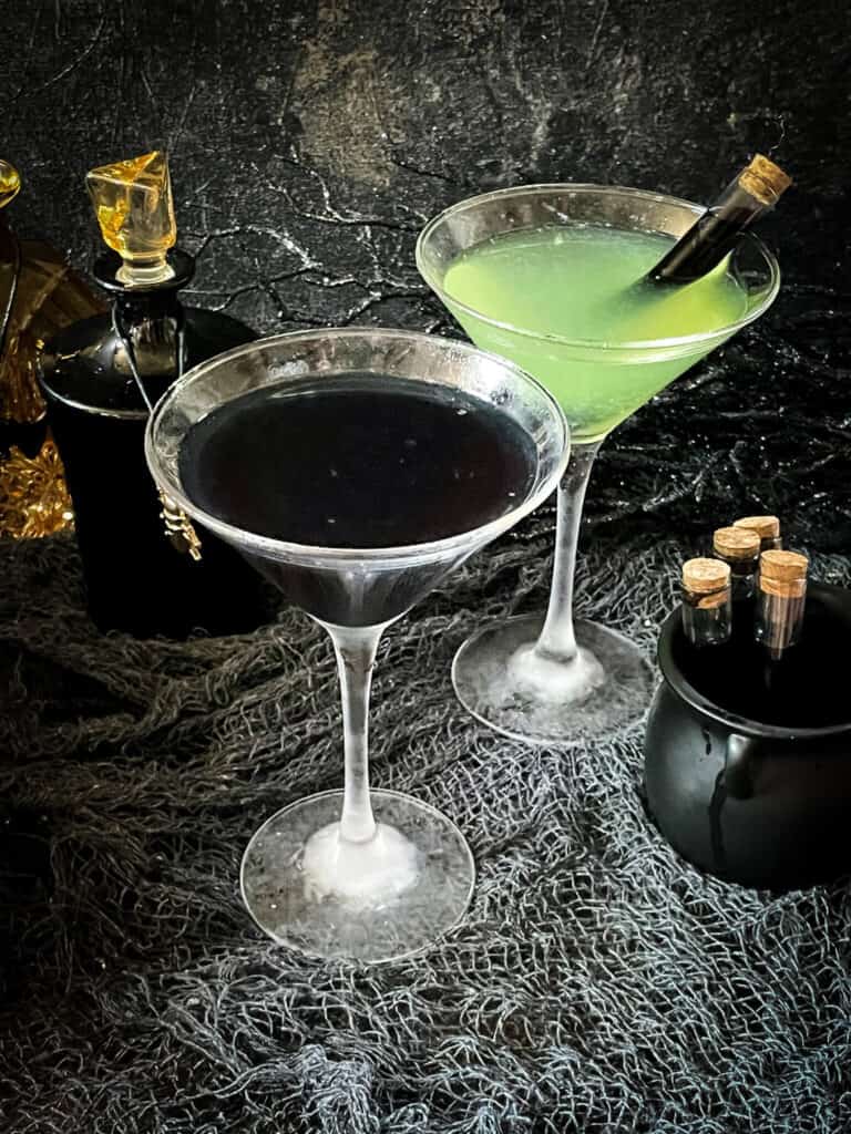 One black cocktail and one green Poison Apple Halloween Cocktail