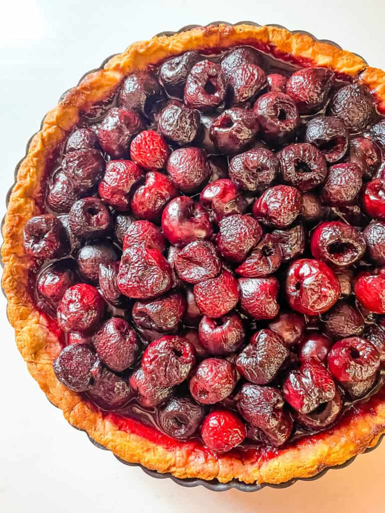 Top view of a whole Cherry Tart on a white counter