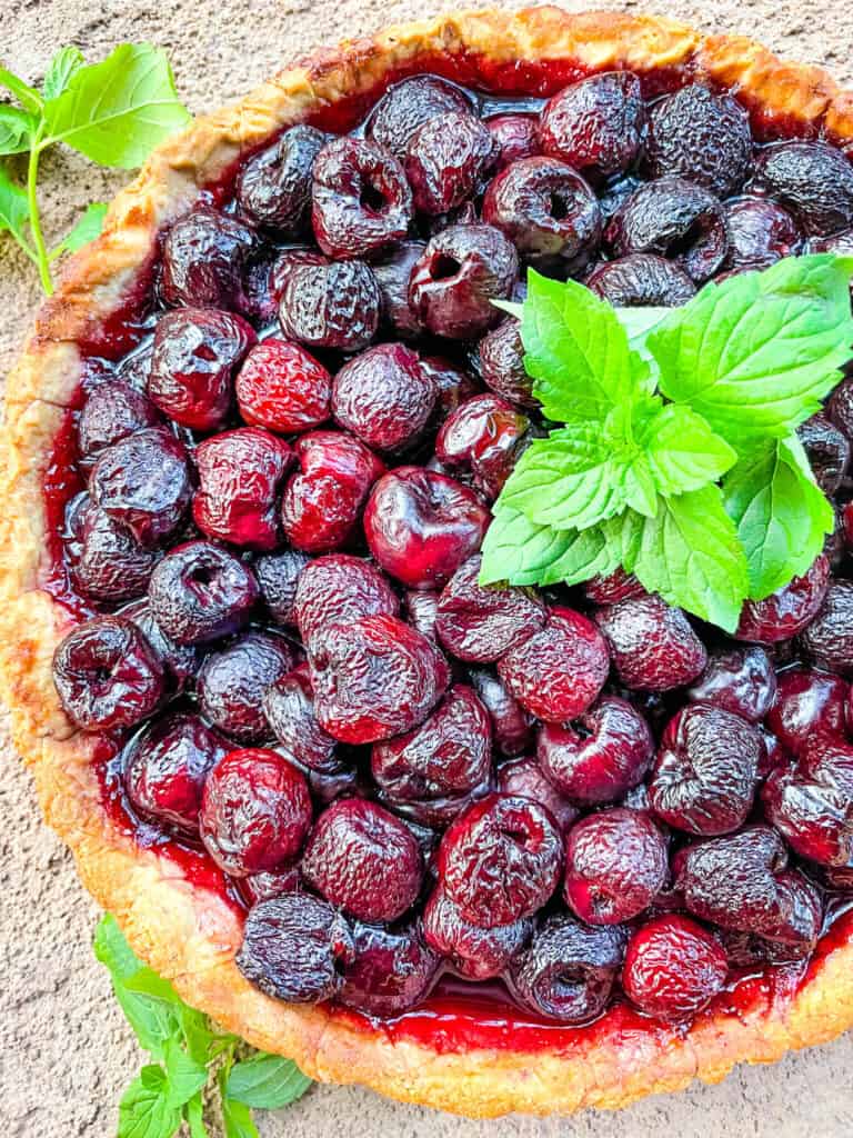 Top view of a Cherry Tart with mint