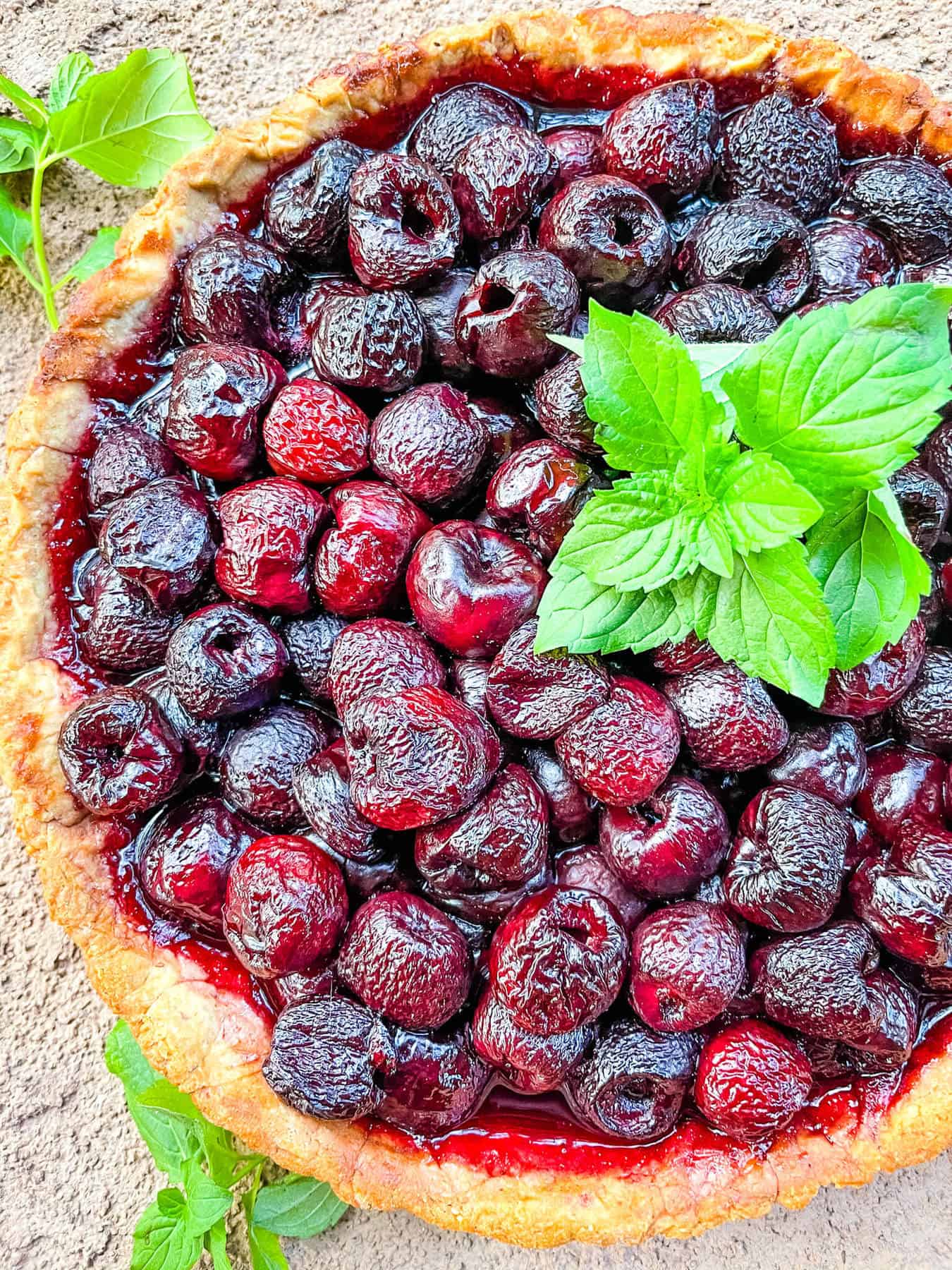 Top view of a Cherry Tart with mint