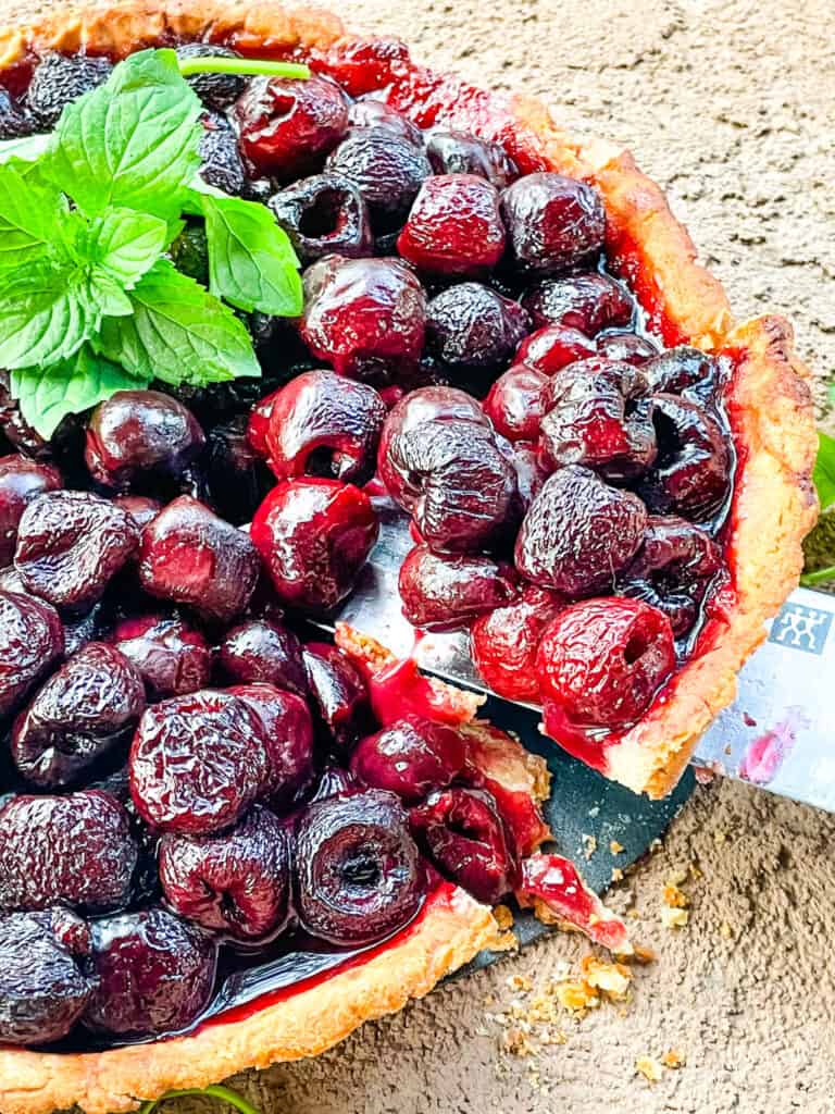 Removing a slice of Cherry Tart from the pan