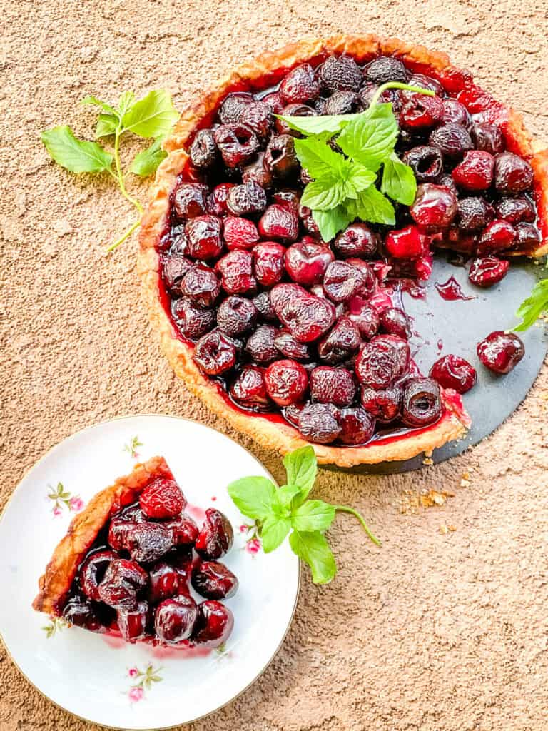 A slice of Cherry Tart next to the remaining tart