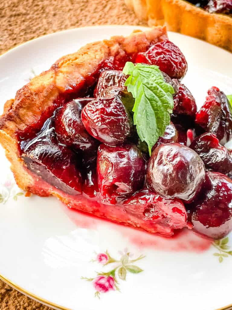 A single slice of Cherry Tart on a white plate