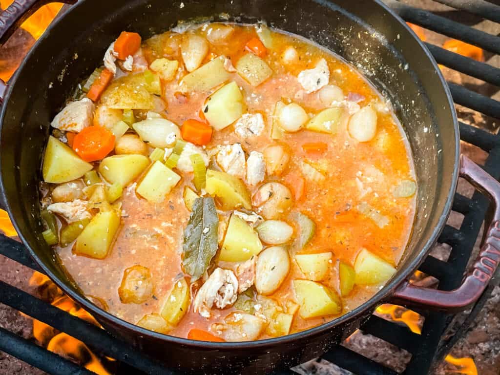 The stew cooking on a fire