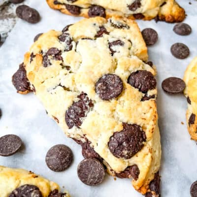 One pastry on parchment with chocolate chips around it