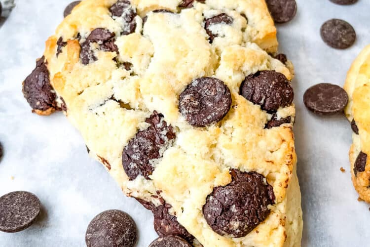 One pastry on parchment with chocolate chips around it