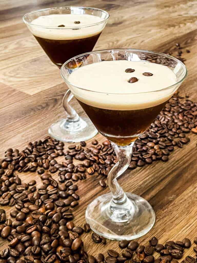 Two full Espresso Martinis with beans around them