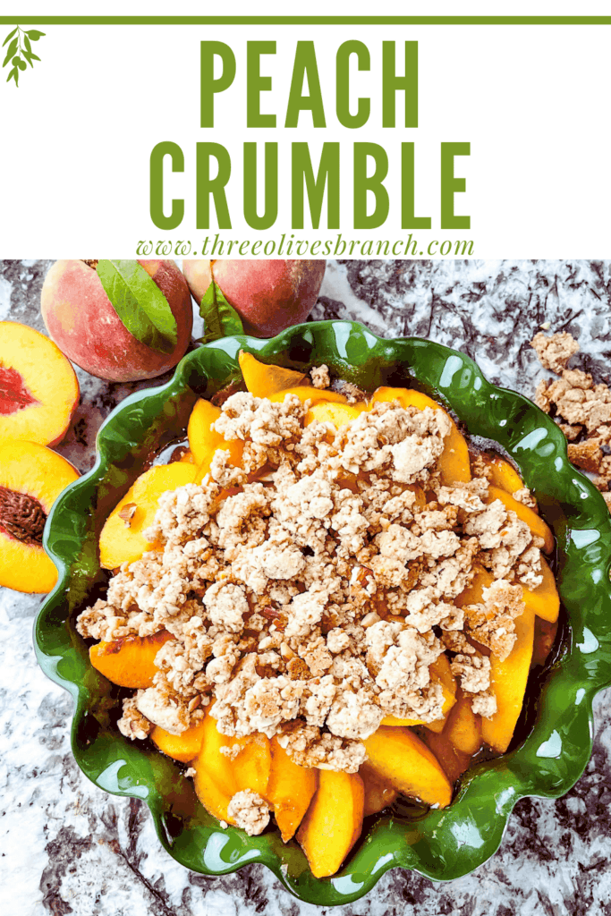 Pin image of top view of Peach Crumble in a green dish with peaches around it and title at top