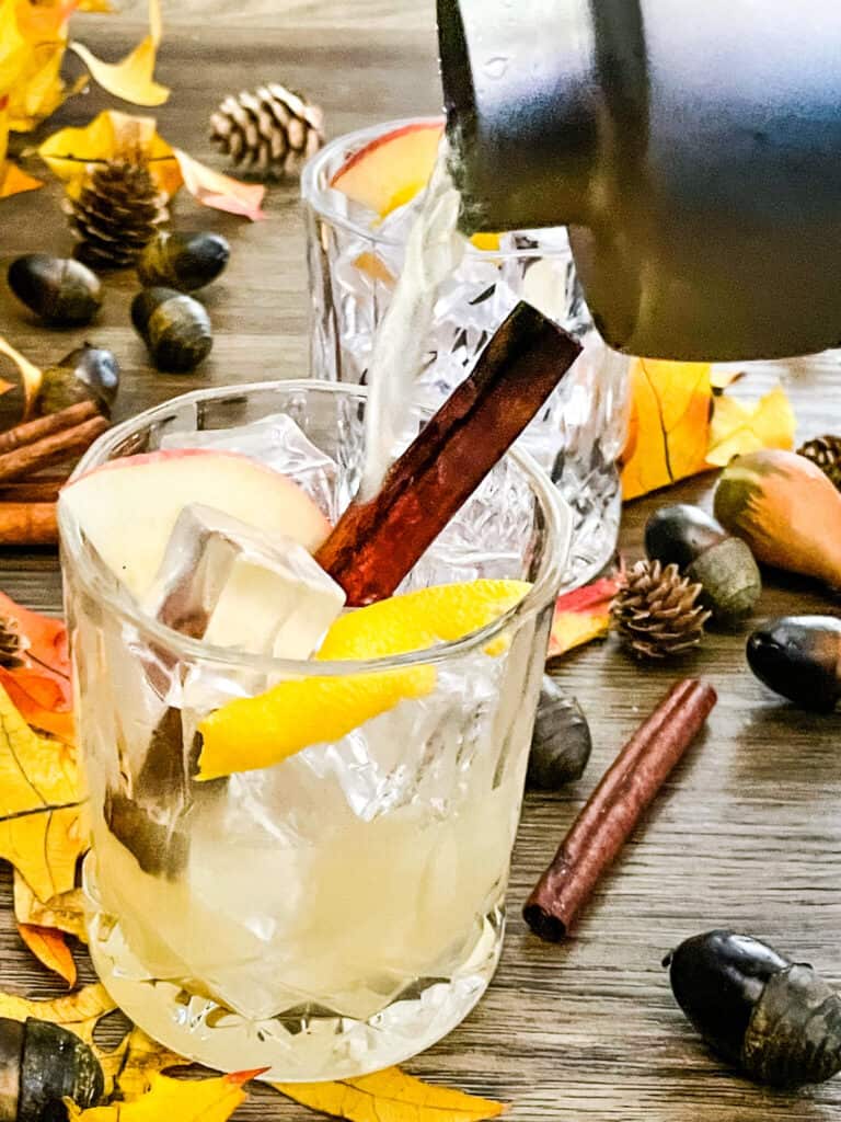 Whiskey Cider Sour being poured into a glass from a shaker