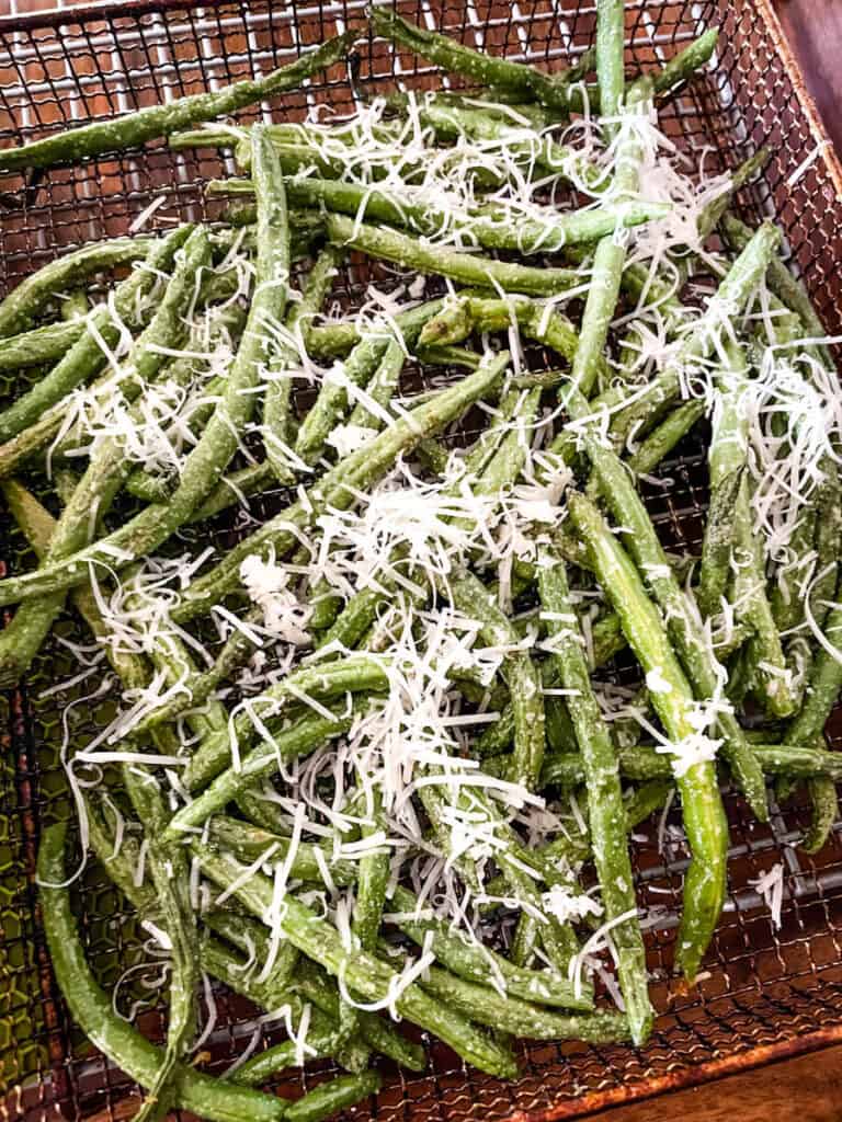 Parmesan Garlic Air Fryer Green Beans half way through cooking in the air fryer